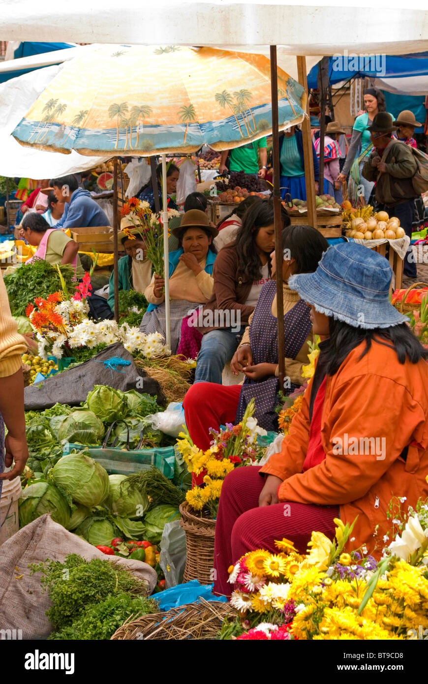 Le Pérou, la Vallée Sacrée, Pisac, marché du dimanche, rangée de femme vendant des légumes verts, des fleurs Banque D'Images