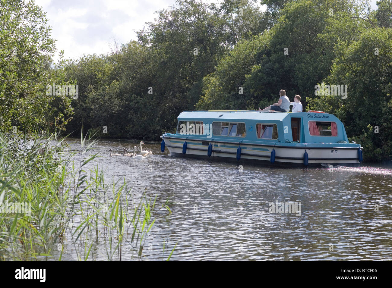 Famille loisirs plaisance dans un Motor Cruiser, rivière Ant, Norfolk Broads. Banque D'Images