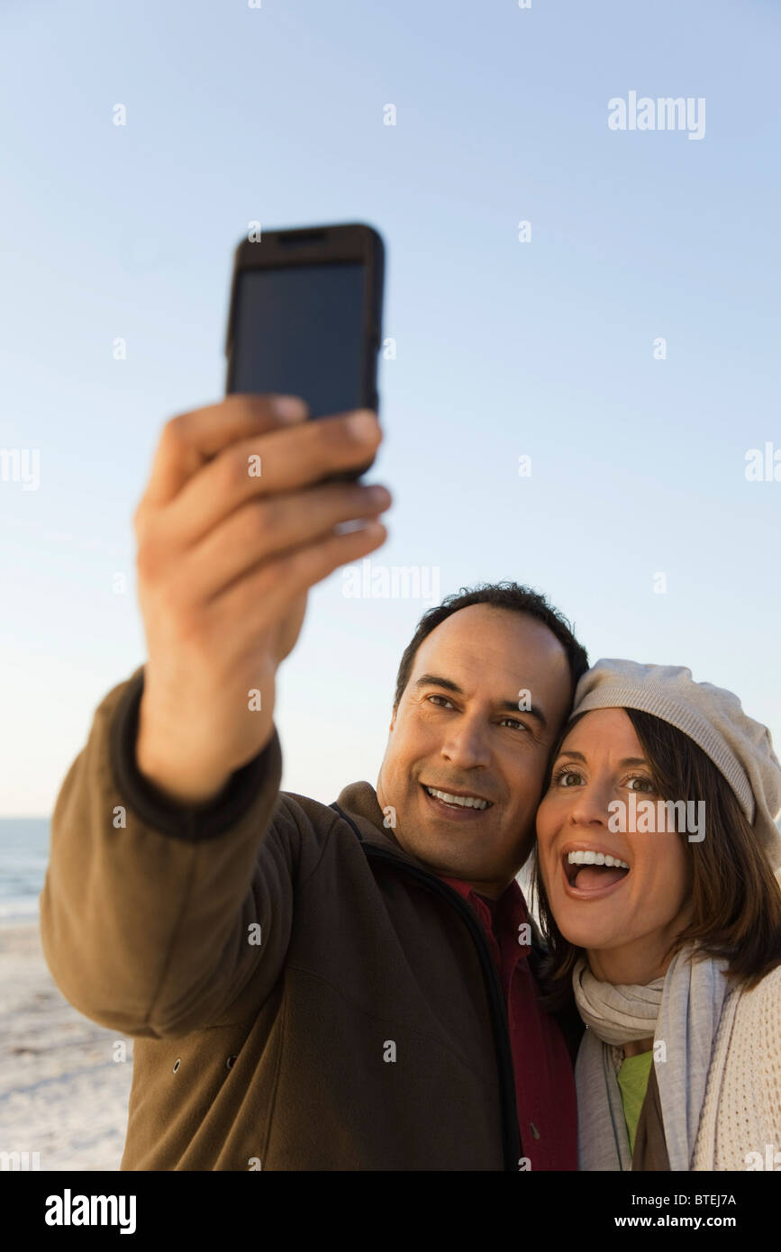 Mature couple photographing themselves with photophone Banque D'Images