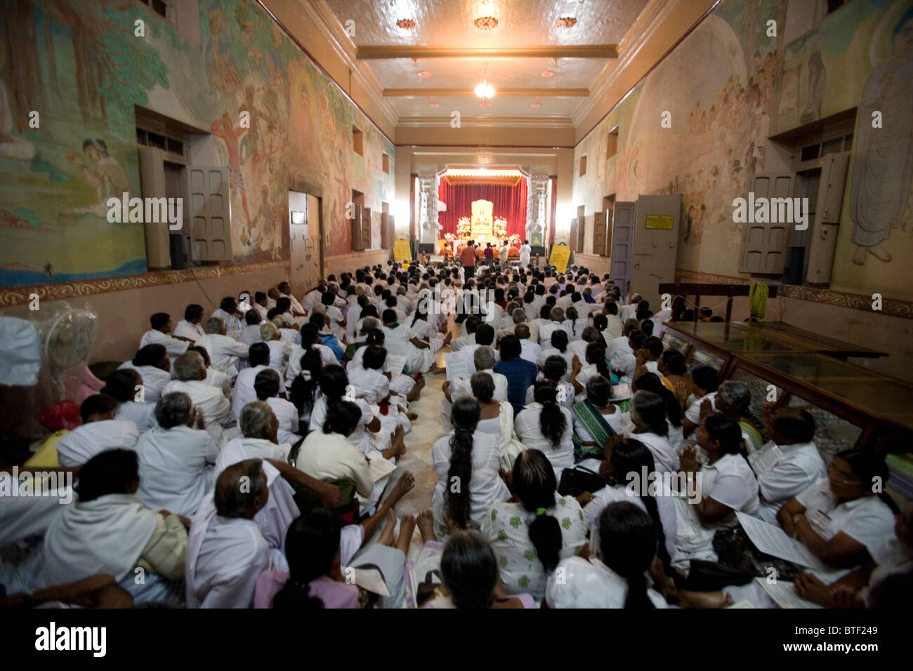 Croyants adorant Bouddha à l'intérieur de Mulagandha Kutir Vihara, Sarnath, Inde. Banque D'Images