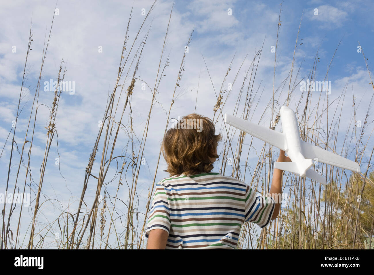 Boy Playing with toy airplane Banque D'Images