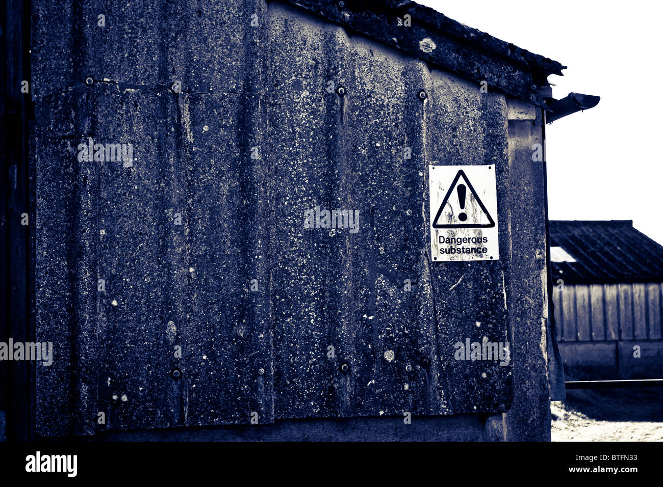 Grunge fond bâtiment abandonné avec panneau d'avertissement désaturées. Banque D'Images