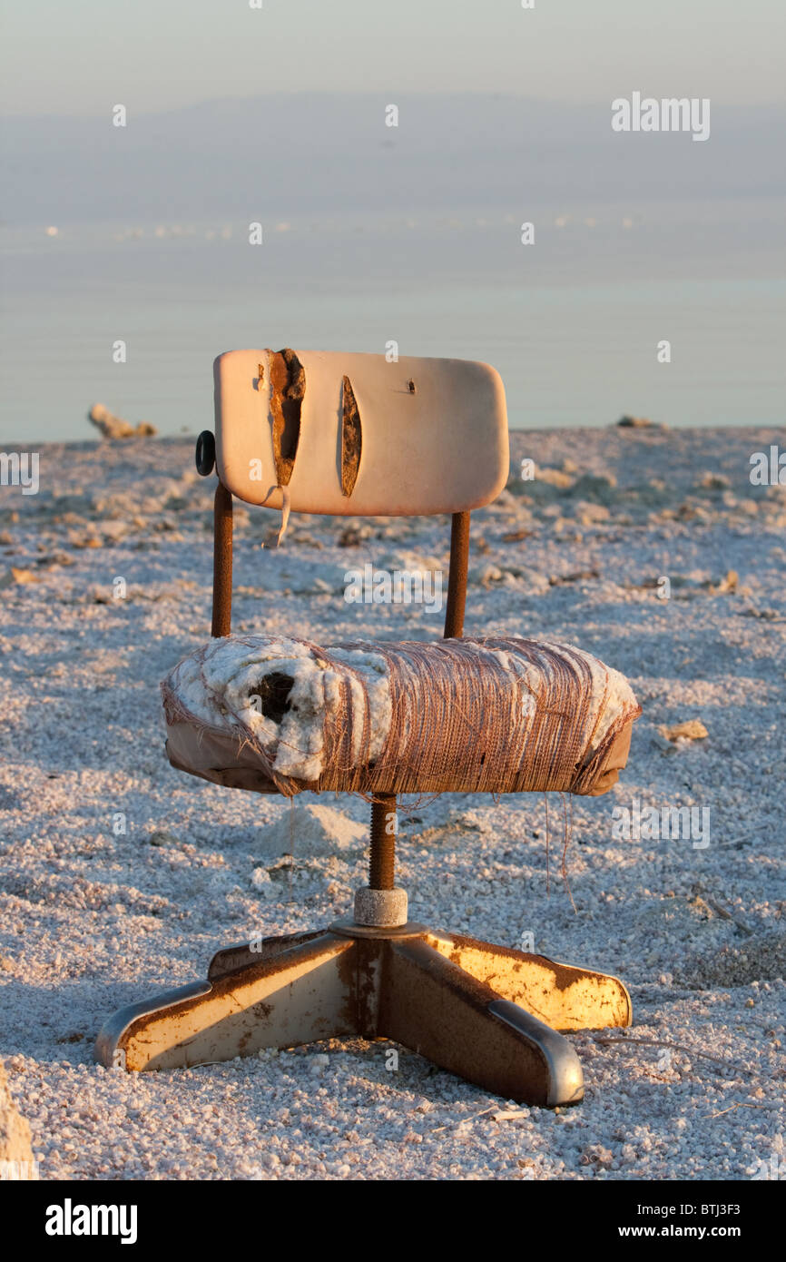 Une chaise de bureau brisé le long de la côte près de Bombay Beach au lac Salton, California Banque D'Images