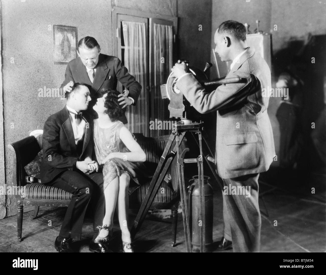 Edmund Goulding Directeur de la MGM (arrière gauche), d'aider William Twiddy (à gauche), et Bill Easton, baiser sur le plateau, tout en faisant un film avec Banque D'Images