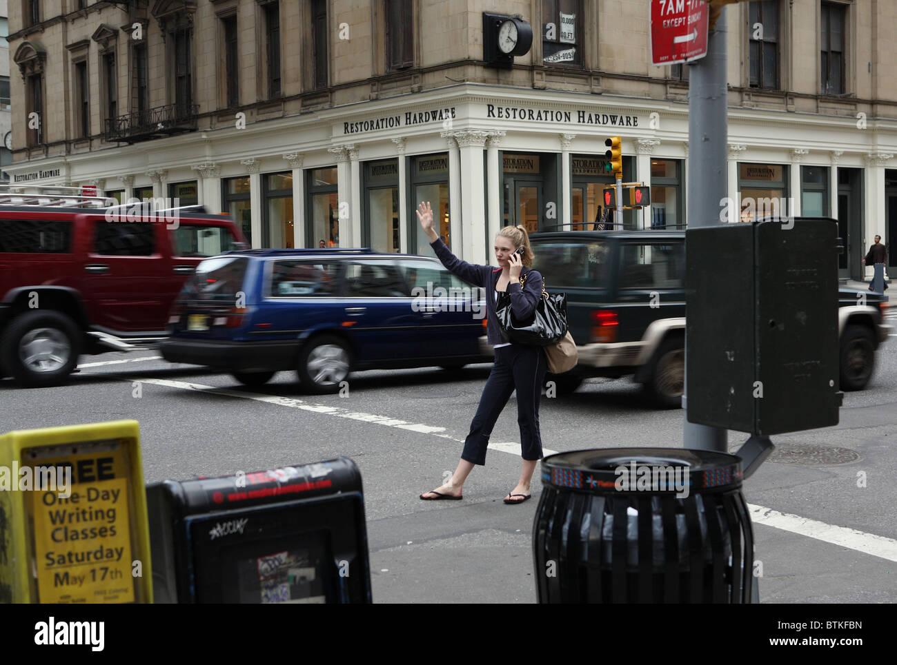 Une femme brandissant un taxi, New York City, USA Banque D'Images