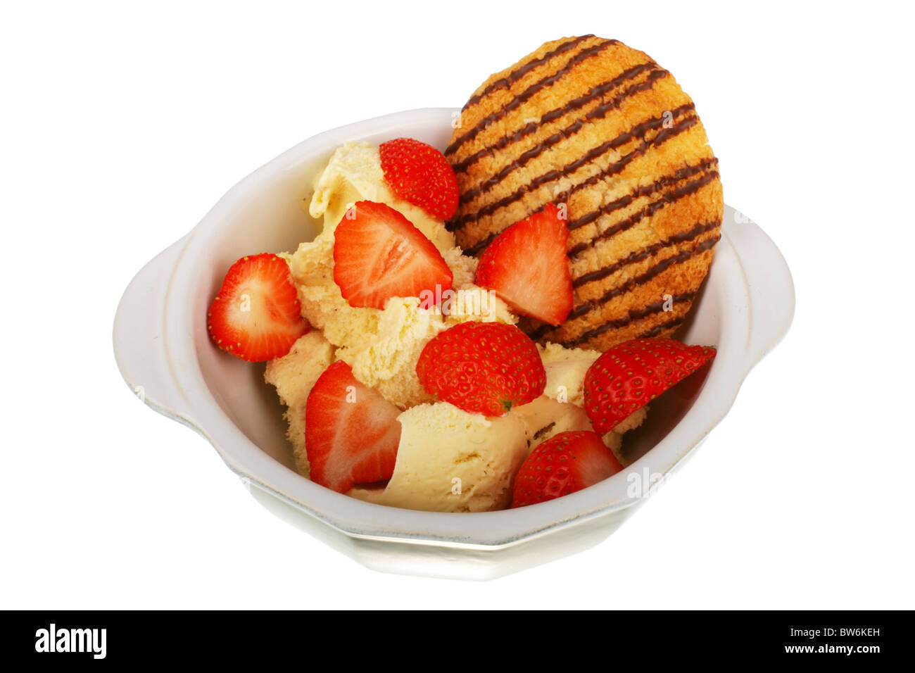 Crème glacée à la vanille avec des fraises et un macaron Banque D'Images