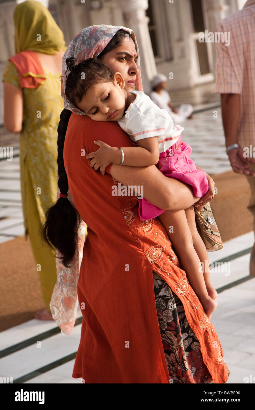 Une femme indienne portant son enfant, le Golden Temple, Amritsar, Punjab, India Banque D'Images