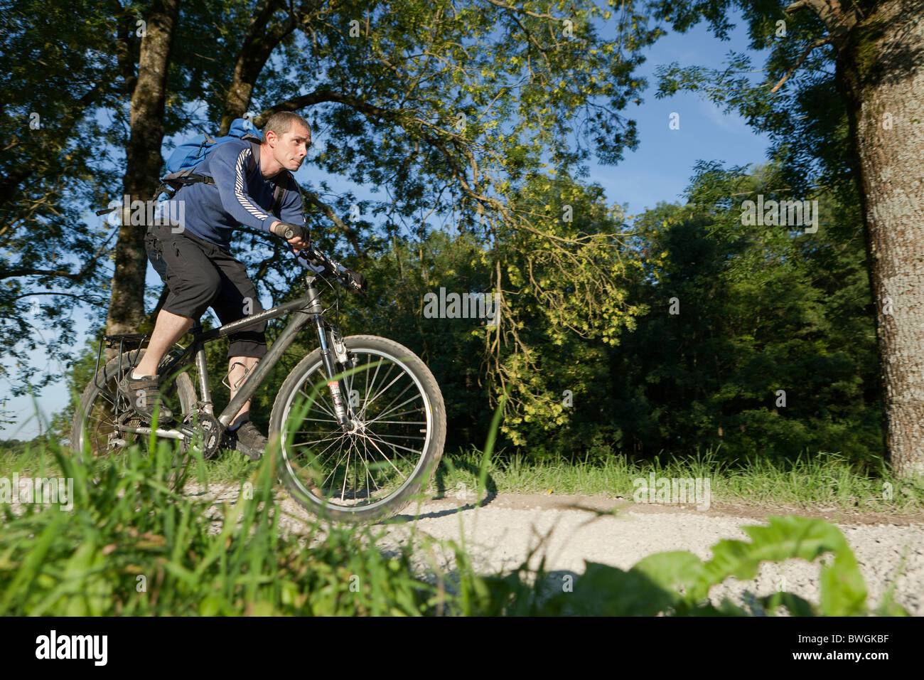 L'homme à vélo sur un chemin de gravier Banque D'Images