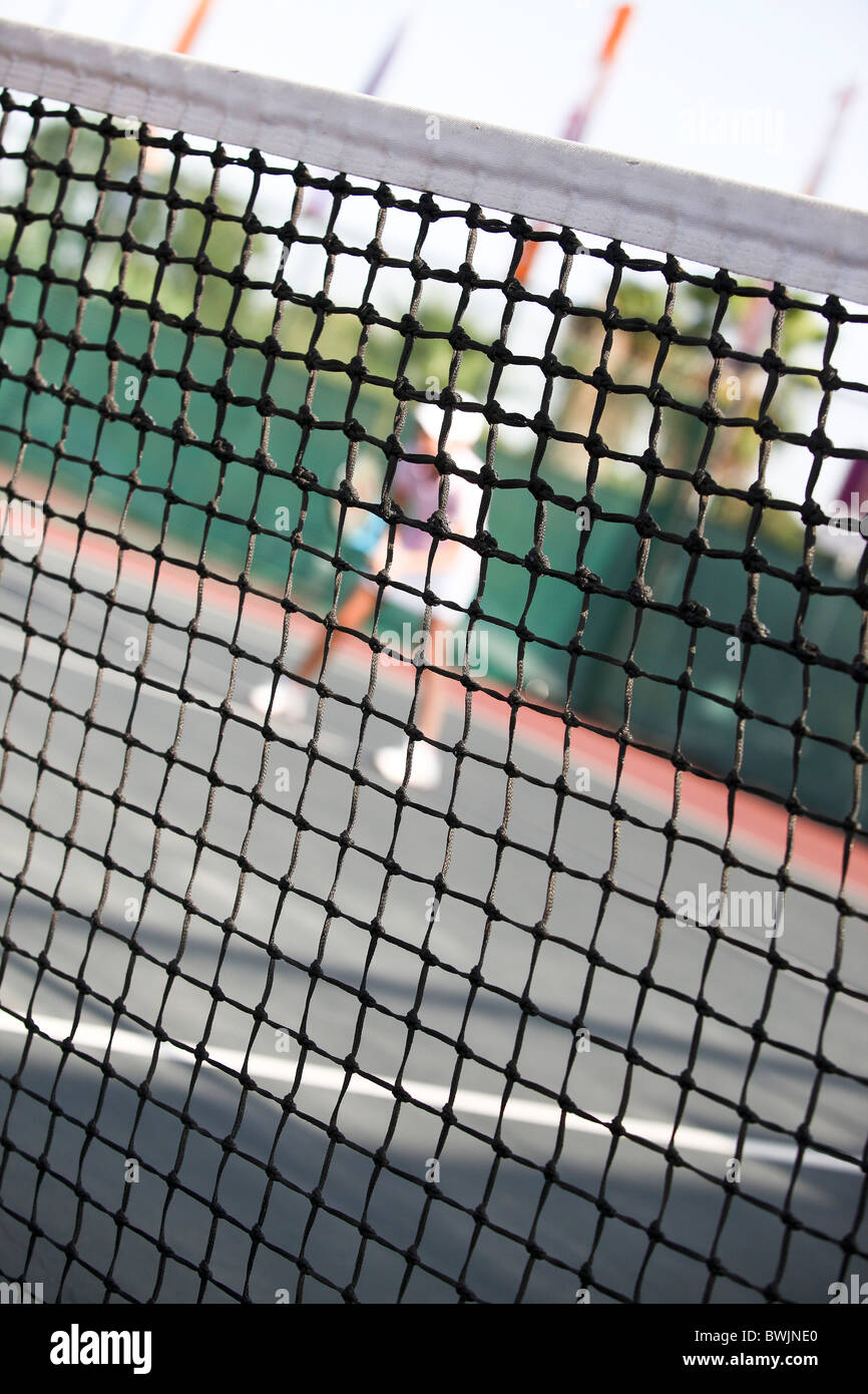 Concept tennis Blured figure d'un joueur de tennis derrière le filet Banque D'Images