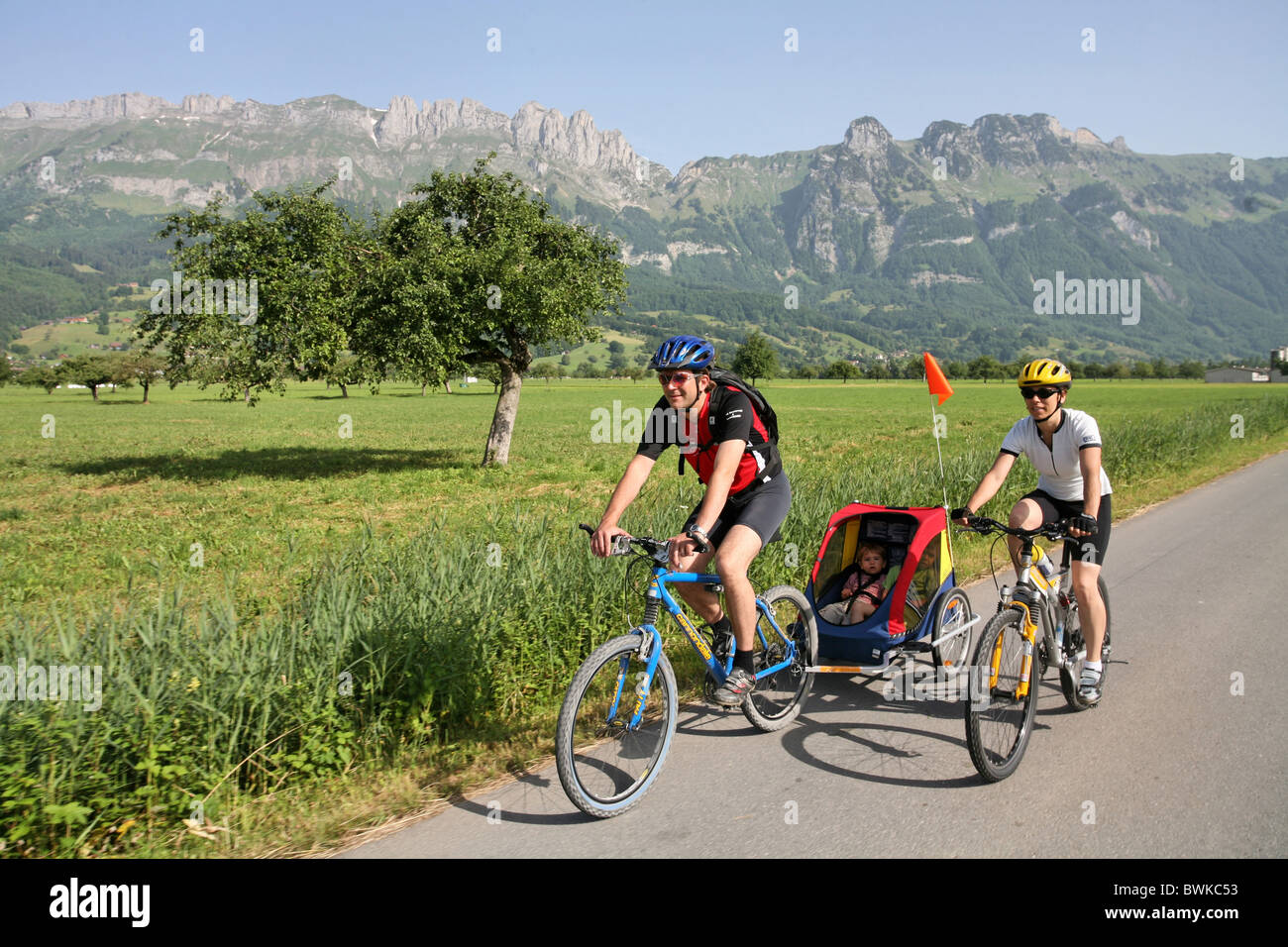Couple famille adepte des vélos enfant remorque vélo Vélos vélo Vélo bicyclette Bicycle riding a bike spor Banque D'Images