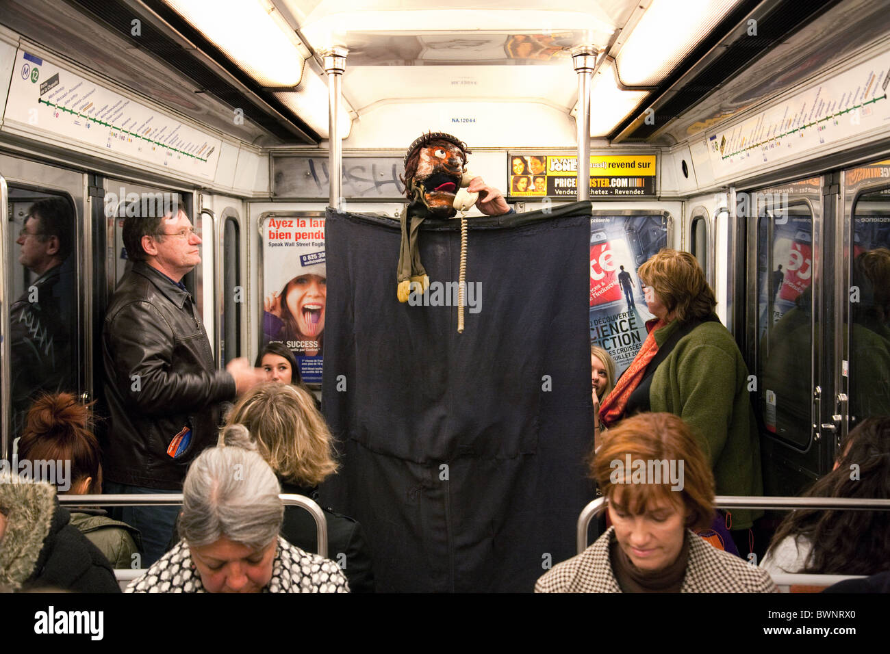 Les gens sur le métro parisien sont divertis par un spectacle de marionnettes de France Banque D'Images