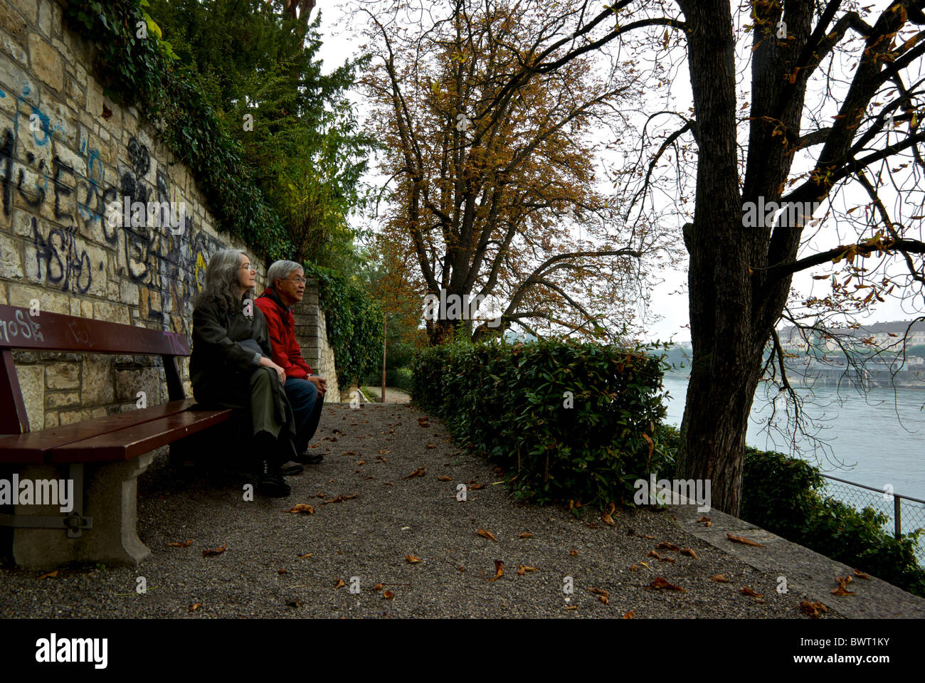 Vieux couple sitting on park bench sur jour d'automne avec vue sur Rhin Basel Suisse Banque D'Images