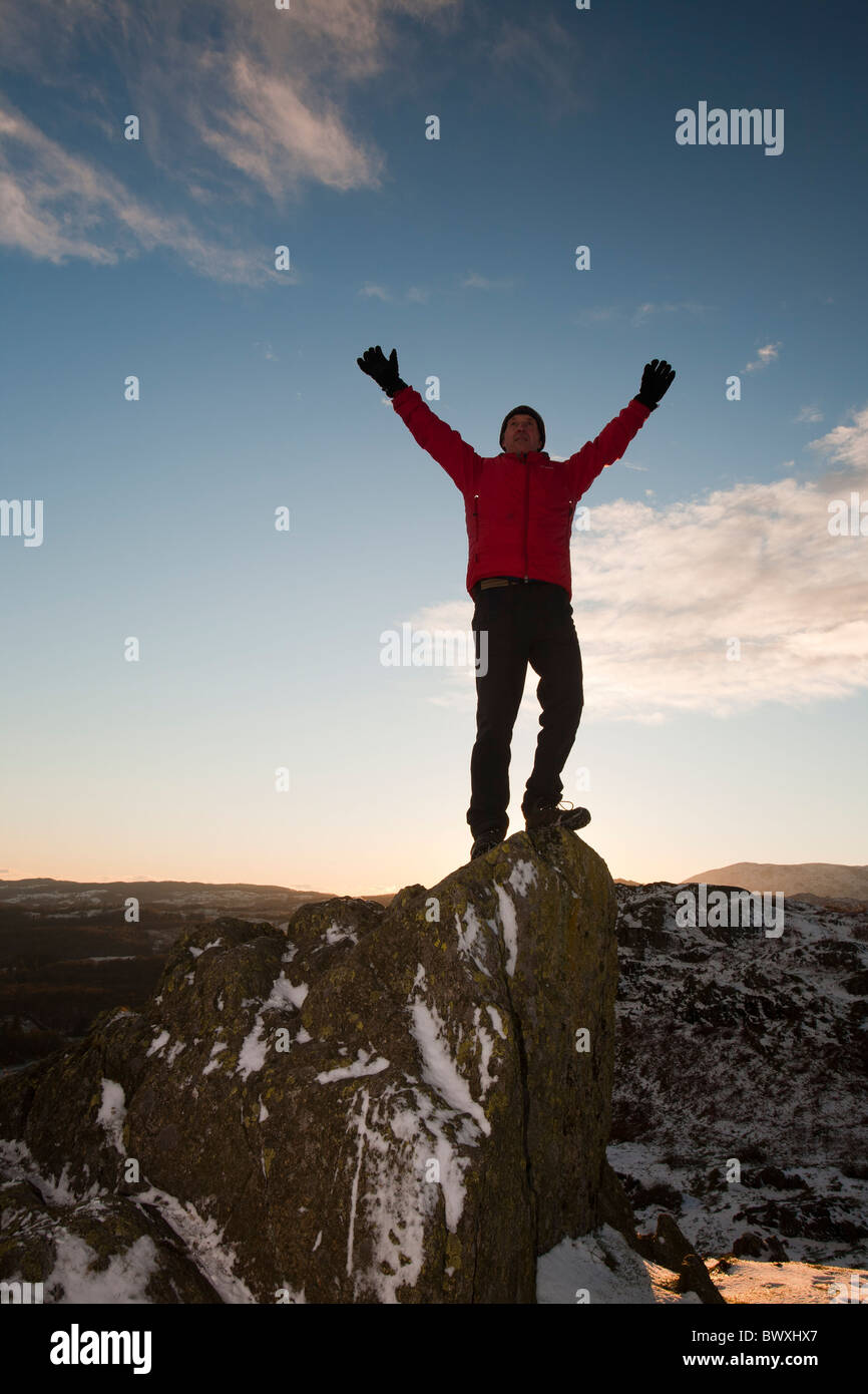 L'alpiniste sur Todd Crag summit dans le Lake District, UK, au crépuscule. Banque D'Images