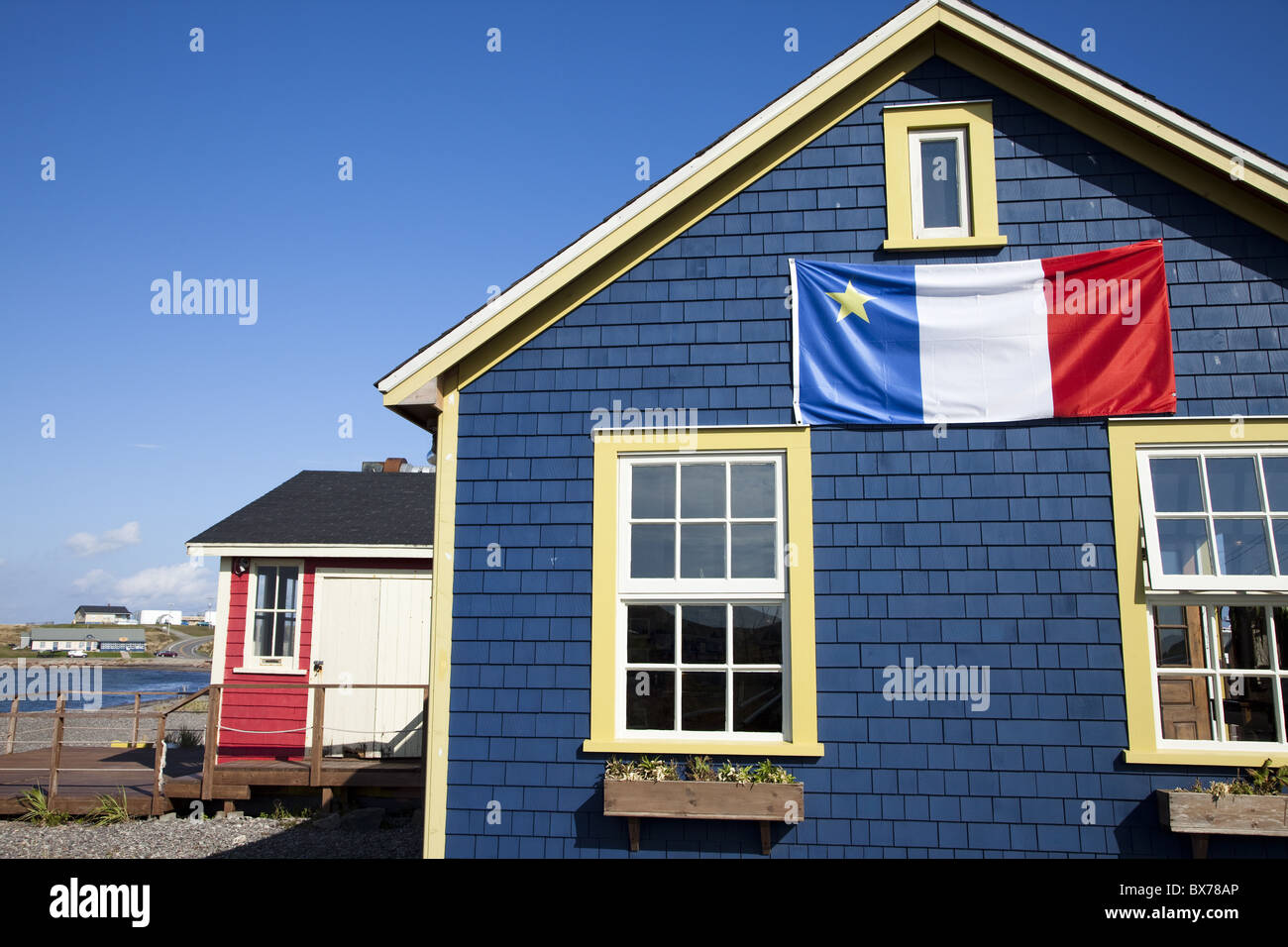 Drapeau acadien sur blue house dans La Grave, Ile Havre-Aubert, l'une des Iles de la Madeleine, golfe du Saint-Laurent, Québec, Canada Banque D'Images