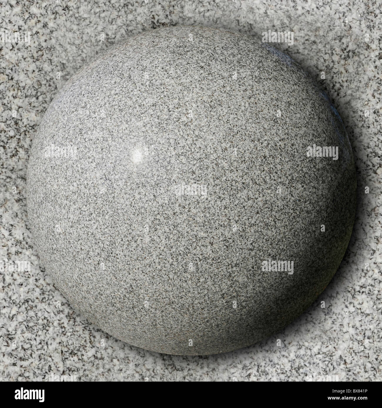 Sphère de pierre contre la surface en granit poli Banque D'Images