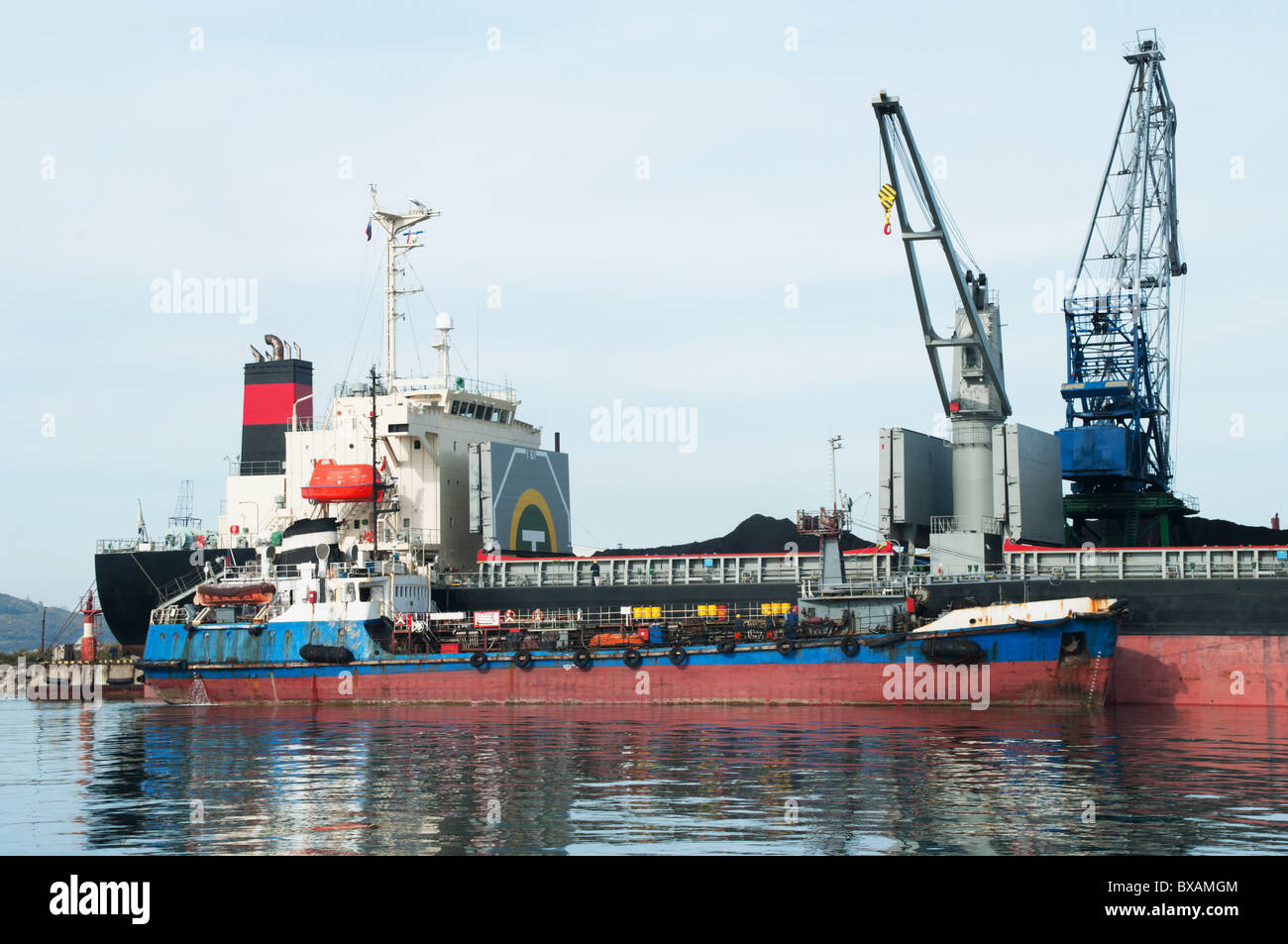 Ravitaillement d'un bateau à port permanent sous le chargement par combustible Banque D'Images