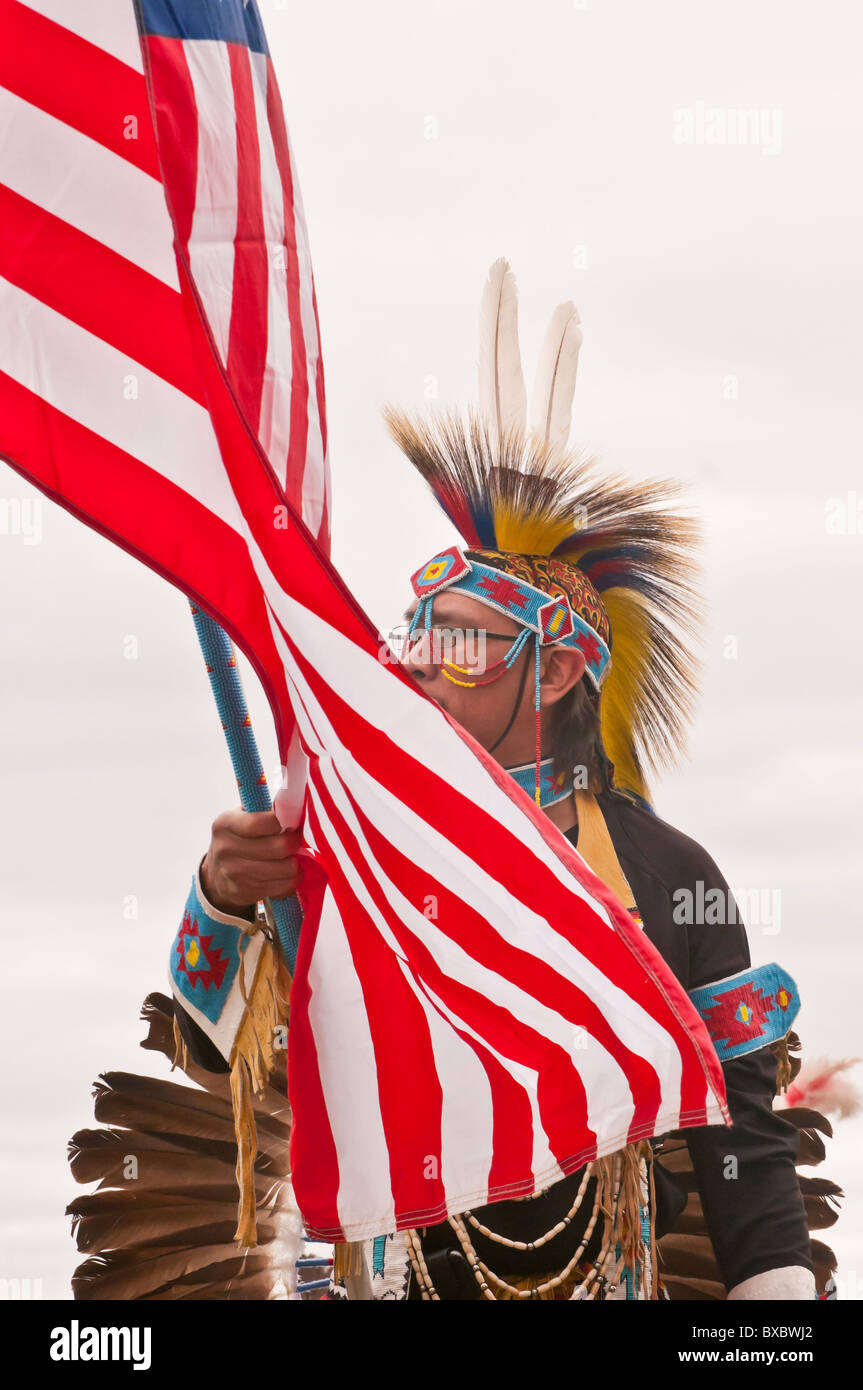 Les mâles adultes des Premières Nations (guerrier), avec le drapeau américain, à un pow-wow, Parc historique Blackfoot Crossing, Alberta, Canada Banque D'Images