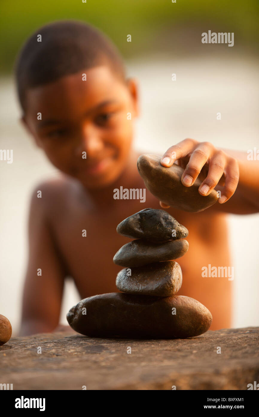 African American boy stacking rocks Banque D'Images