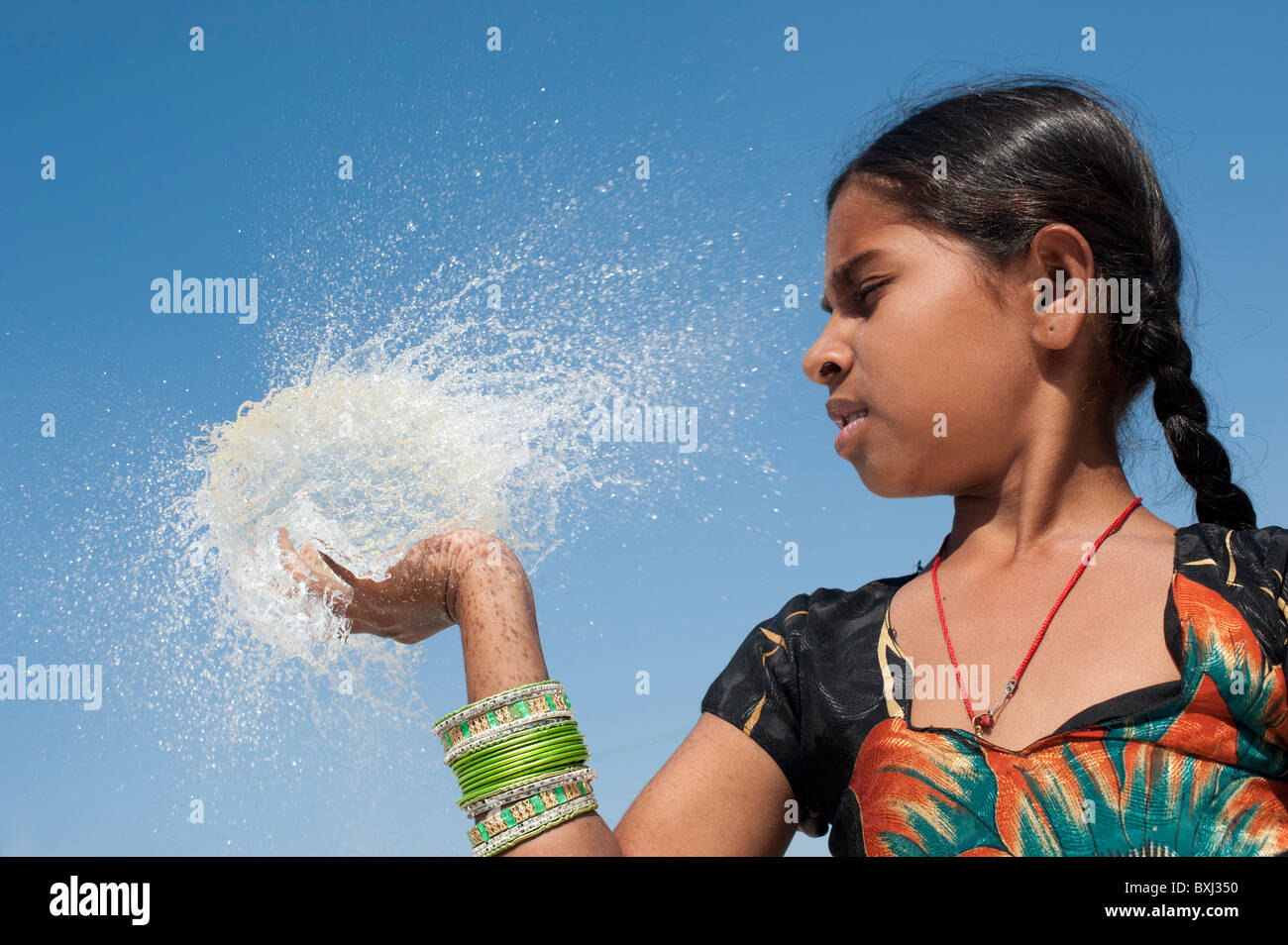 Indian girl tenant à la main un ballon d'eau burst ronde. L'Inde Banque D'Images