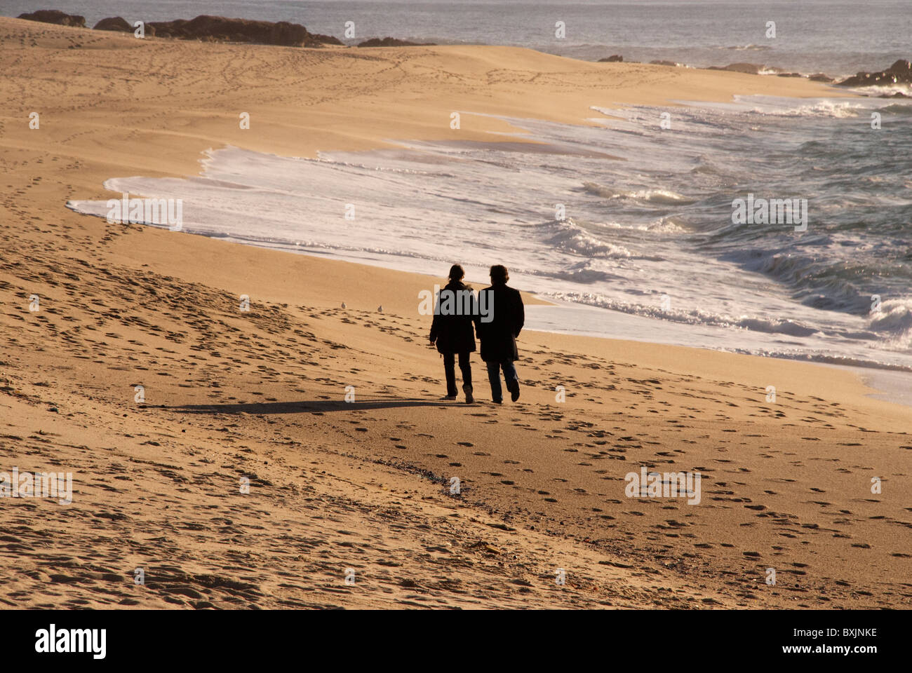 Un couple en tenant le proverbial "longue marche sur la plage'. Vila do Conde, Portugal Banque D'Images