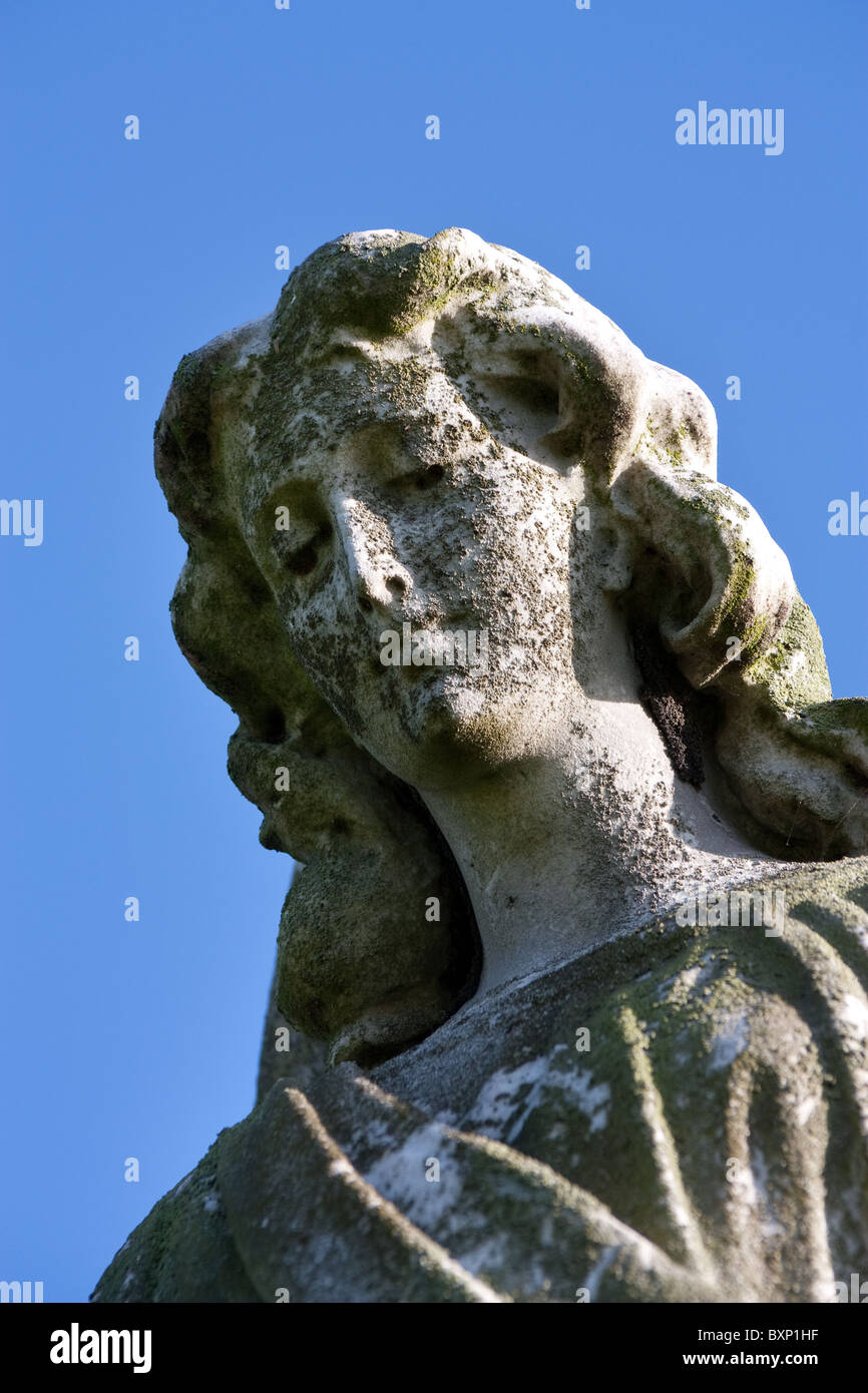 Pierre surmonté d'un ange Monument Cimetière contre ciel bleu vif. Banque D'Images