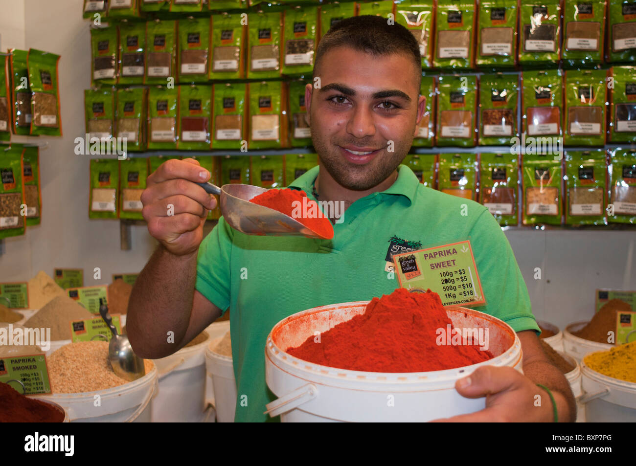 Un vendeur d'épices avec une baignoire de paprika dans marché Rhône-Alpes à Sydney Australie Banque D'Images
