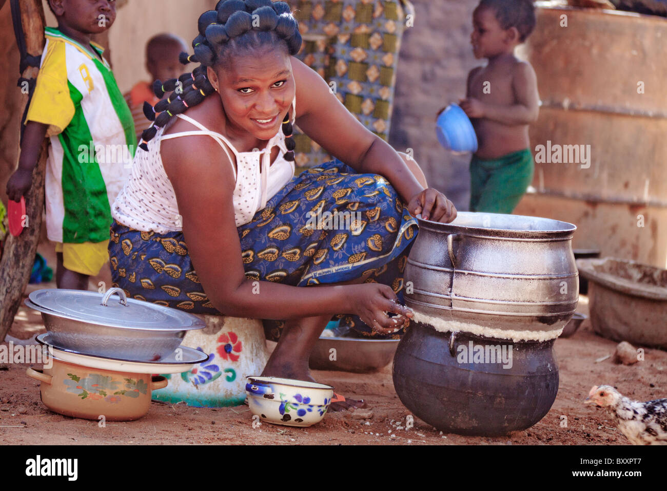 À Djibo dans le nord du Burkina Faso, une femme Peul deux pots joints ensemble pour faire un bateau à vapeur pour le couscous de manioc (attiéké). Banque D'Images