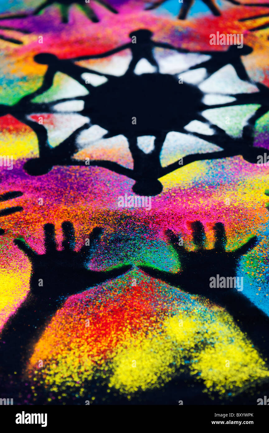 Un symbole d'unité mondiale entouré par la main des enfants d'impressions réalisées avec poudre multicolore Banque D'Images