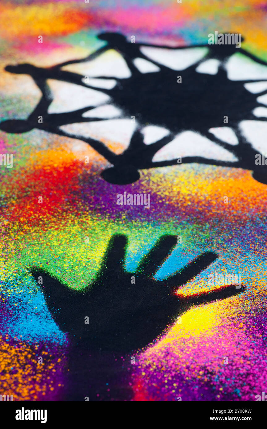Un symbole d'unité mondiale entouré par la main des enfants d'impressions réalisées avec poudre multicolore Banque D'Images