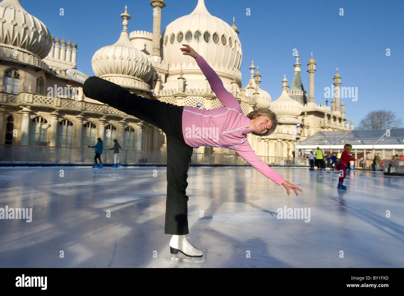 Une femme le patineur sur pop-up temporaire patinoire devant le pavillon royal de Brighton. Banque D'Images