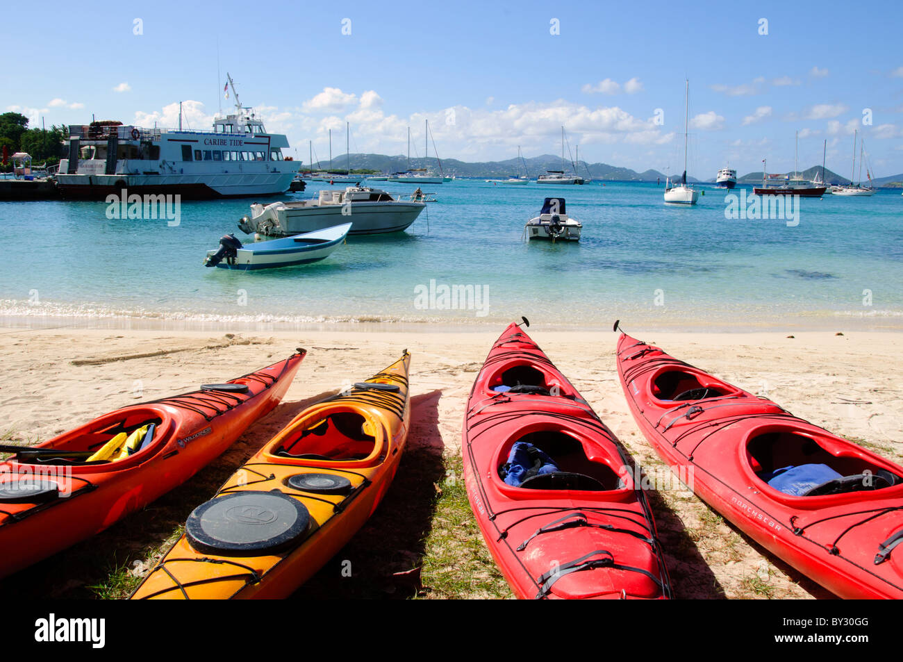 CRUZ BAY, John, Îles Vierges américaines — des kayaks colorés bordent la plage de Christian Cove à Cruz Bay, ville principale et port d'entrée sur les Îles Vierges américaines. Ces embarcations animées offrent aux visiteurs la possibilité d'explorer la côte et de se divertir sur l'eau, mettant en valeur les activités de plein air populaires disponibles sur cette île des Caraïbes. Banque D'Images