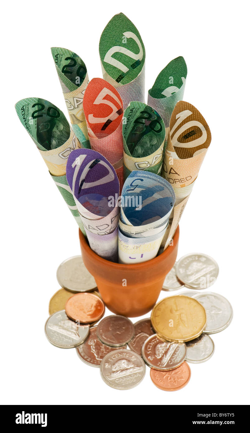 Les projets regroupés dans un pot de terre avec des pièces à la base. Banque D'Images