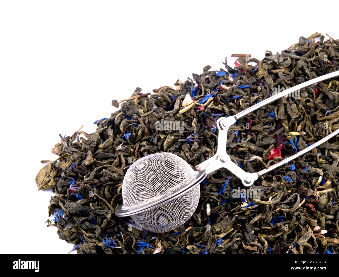 Boule à thé métal et aromatiques la feuille de thé vert sur fond blanc. Banque D'Images