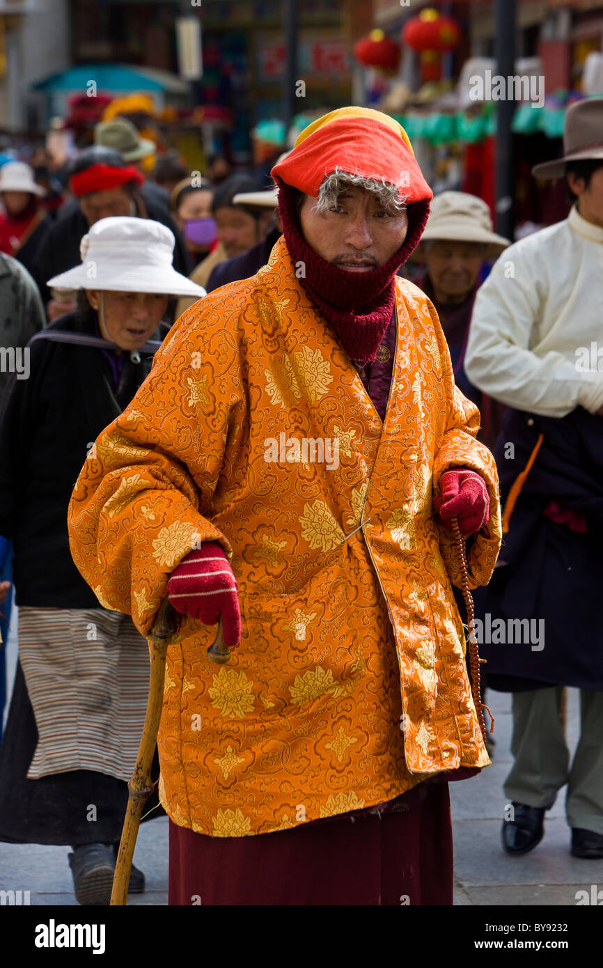 Pèlerin tibétain de l'homme portant des armoiries d'or brillant dans le Barkhor Lhassa au Tibet. JMH4475 Banque D'Images