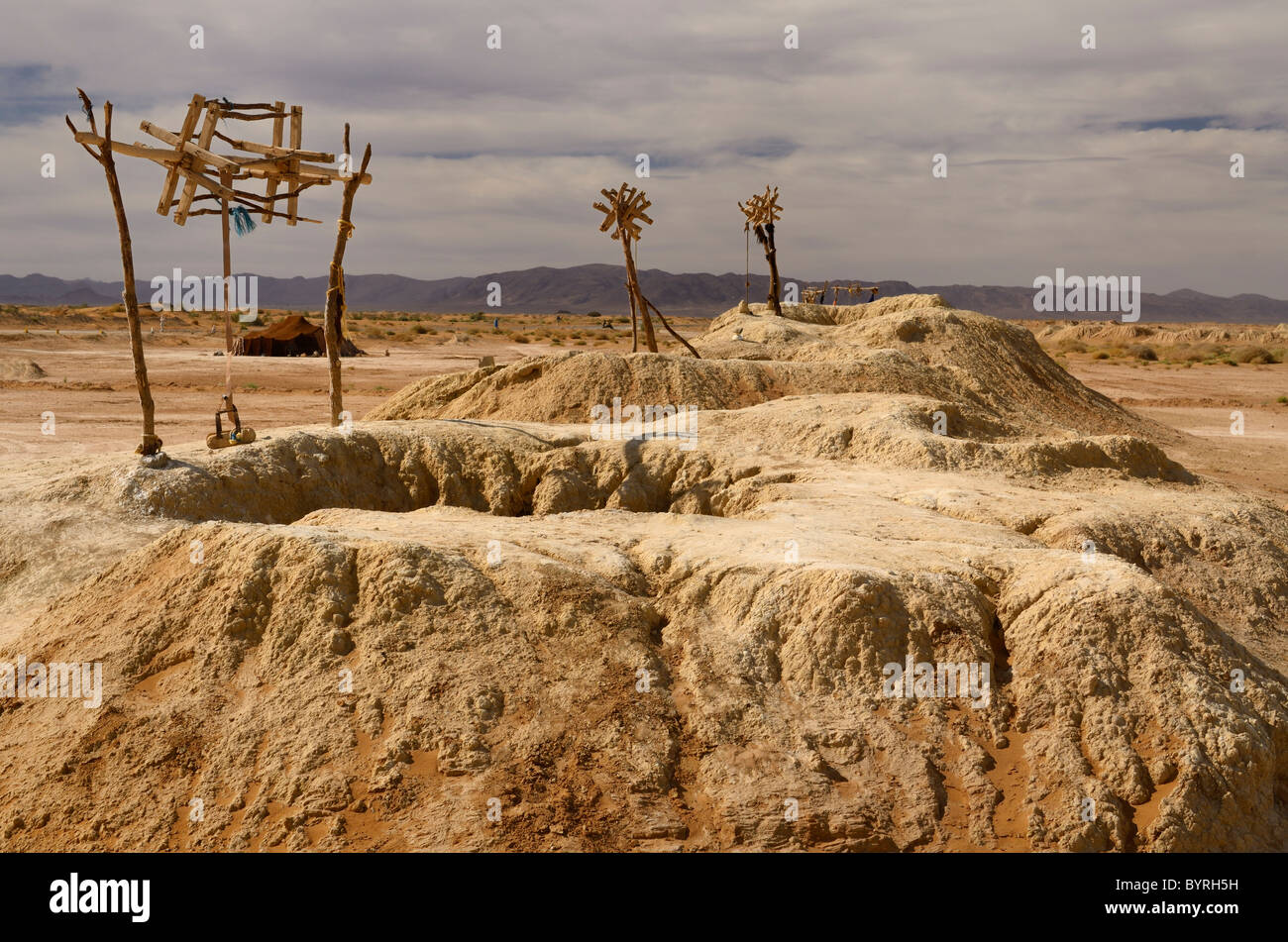 Tente berbère et des monticules de terre avec poulies sur Khettara dans le puits du bassin du Tafilalt arides du Maroc Afrique du Nord Banque D'Images