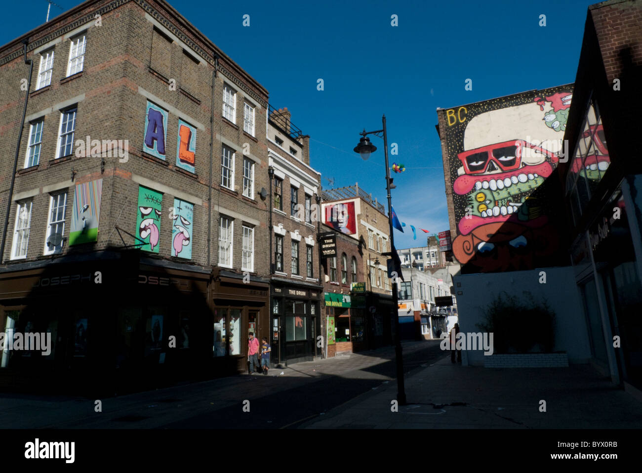 Deux garçons à marcher le long de la rue Whitecross décorées avec des artistes travaillent London EC2 England UK KATHY DEWITT Banque D'Images