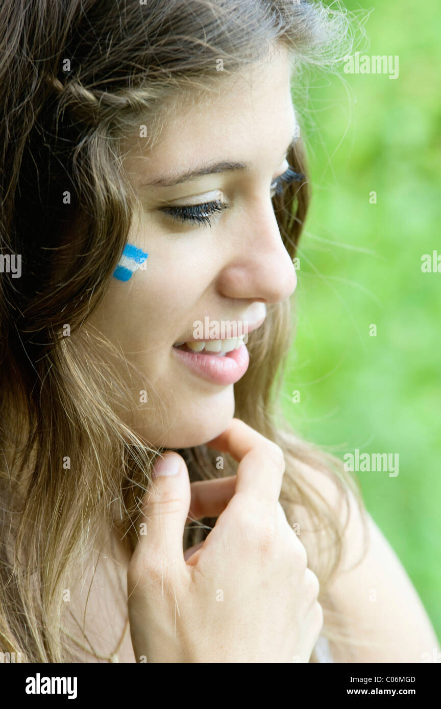 Portrait d'une jeune femme d'argentine avec le drapeau argentin sur sa