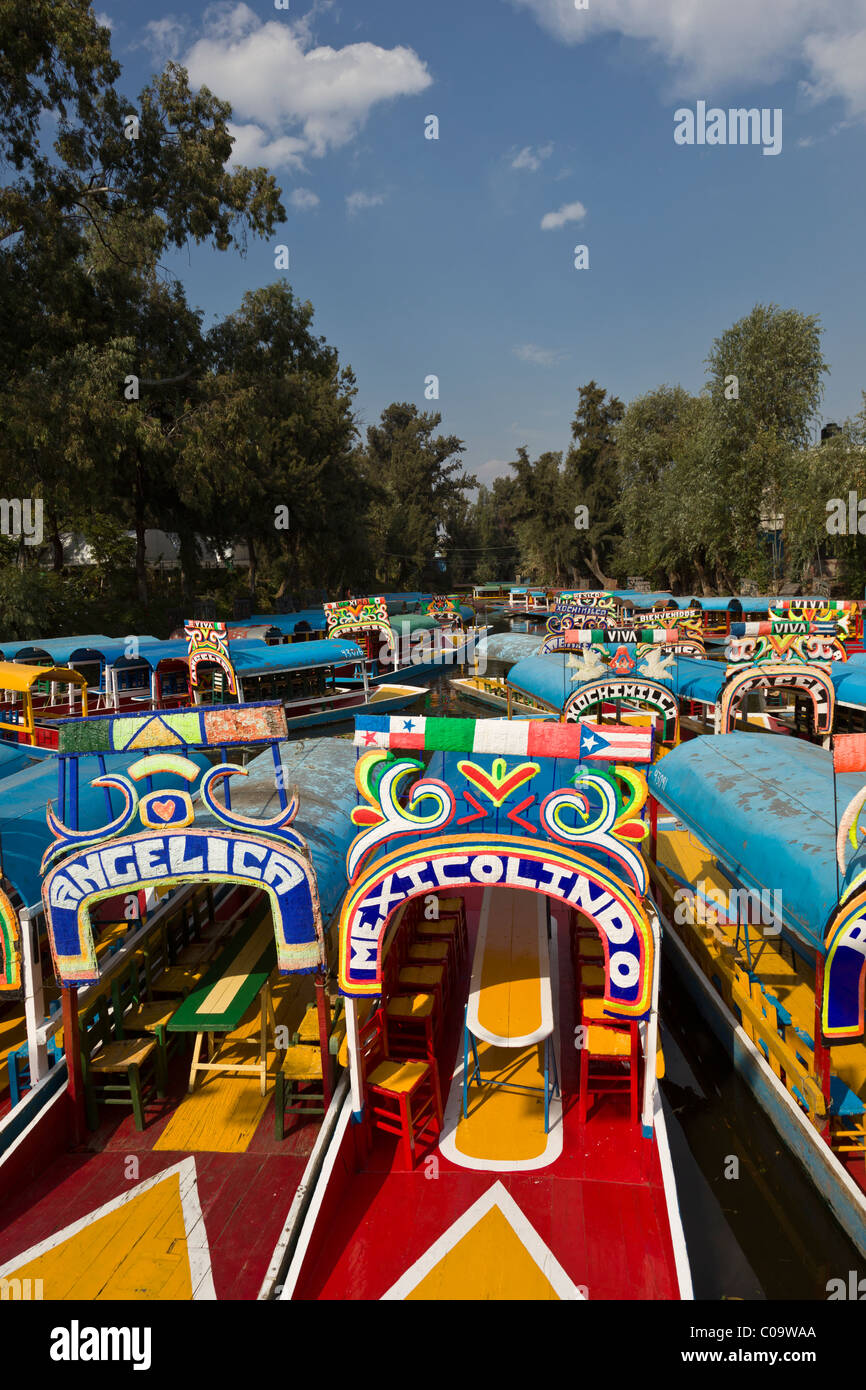 Canal coloré ou bateaux à touristes attendent trajineras Xochimilco ou 'les jardins flottants' dans le sud de la ville de Mexico. Banque D'Images Canal coloré ou bateaux à touristes attendent trajineras Xochimilco ou 'les jardins flottants' dans le sud de la ville de Mexico. Banque D'Images