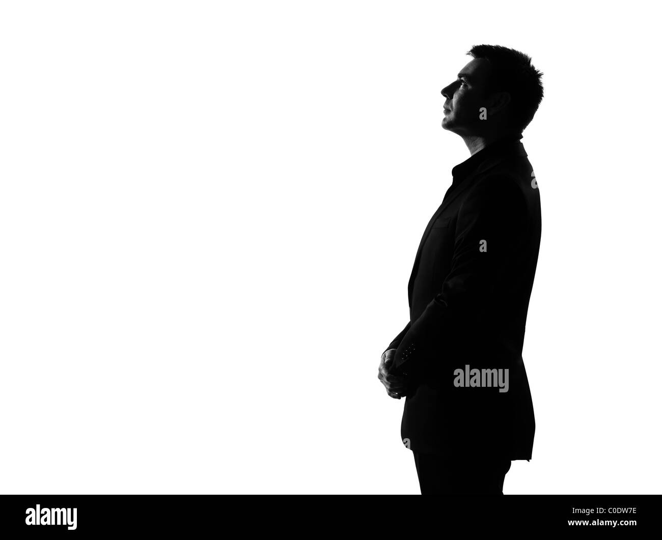 Silhouette caucasian business man jusqu'à la grave profil comportement exprimant toute la longueur sur studio isolé sur fond blanc Banque D'Images