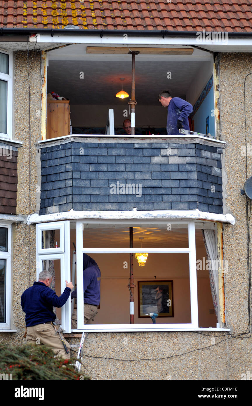 Nouvelles fenêtres en cours d'installation sur une maison, UK (uniquement pour utilisation dans des histoires positives sur le remplacement des fenêtres) Banque D'Images