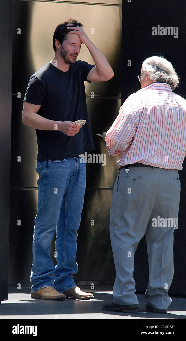 Keanu Reeves reçoit un paquet à la maison et ne pouvait pas faire les calculs pour la bonne quantité d'argent liquide pour payer le livreur Banque D'Images