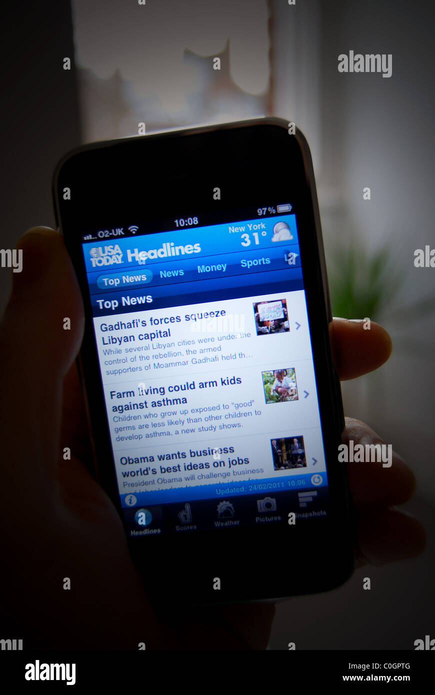 Illustration d'une photo d'une personne titulaire d'un iphone 3gs, montrant les USA aujourd'hui fournisseur de contenu Nouvelles app Banque D'Images