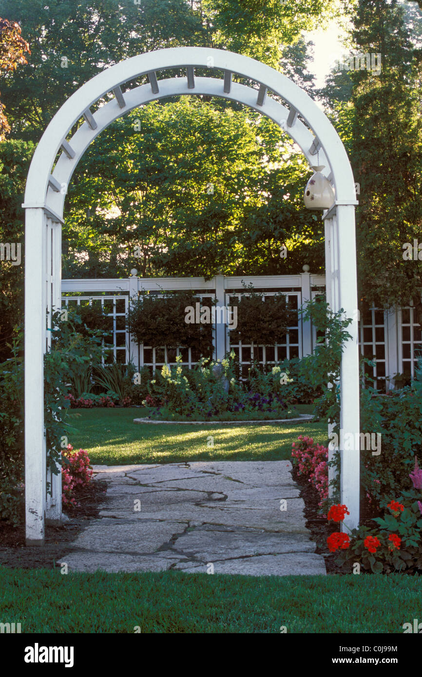 Cadres EN BOIS BLANC ARBOR VOIE PIERRE JARDIN au Minnesota. CATMINT NEPETA Les bégonias et chemin de la frontière. Banque D'Images