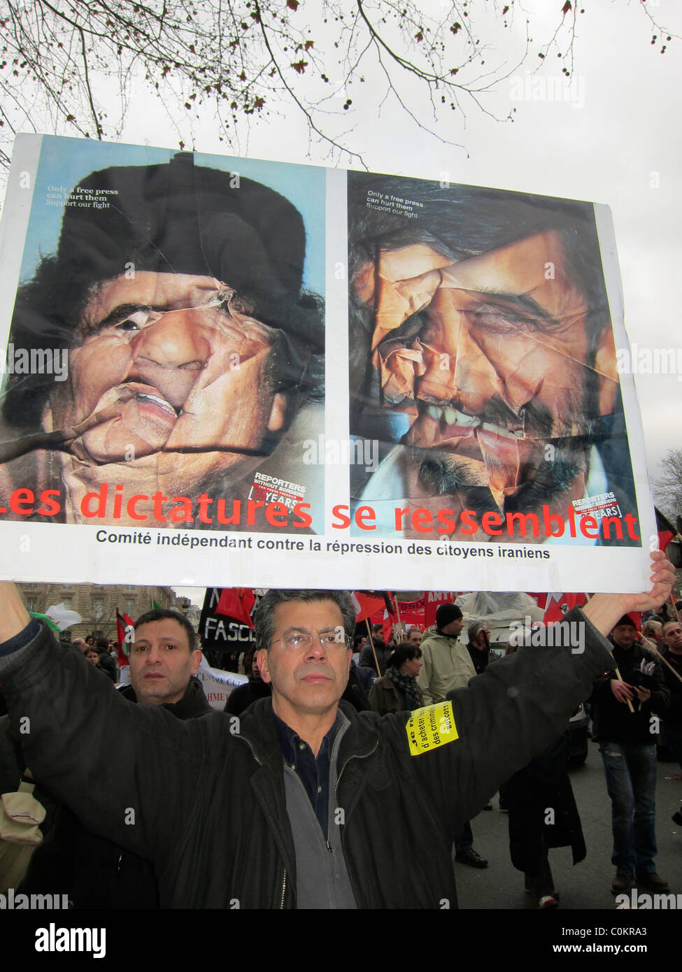 Paris, France, affiche de protestation française Libye démonstration, en soutien à la révolution libyenne, Homme tenant signe avec photos de Kadhafi sur la rue, printemps arabe, politique Banque D'Images