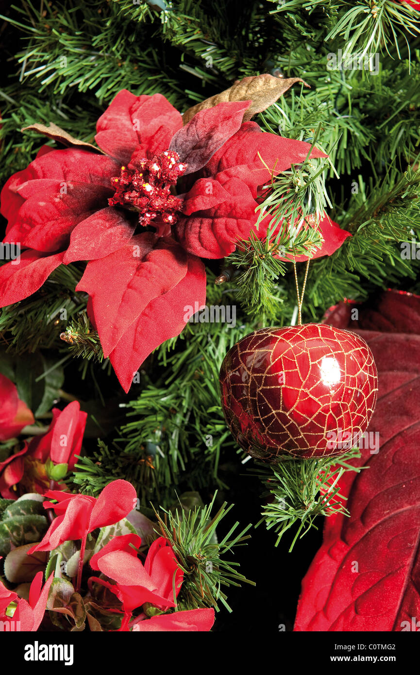 Détail de l'arbre de Noël décoré de poinsettia et babioles Banque D'Images