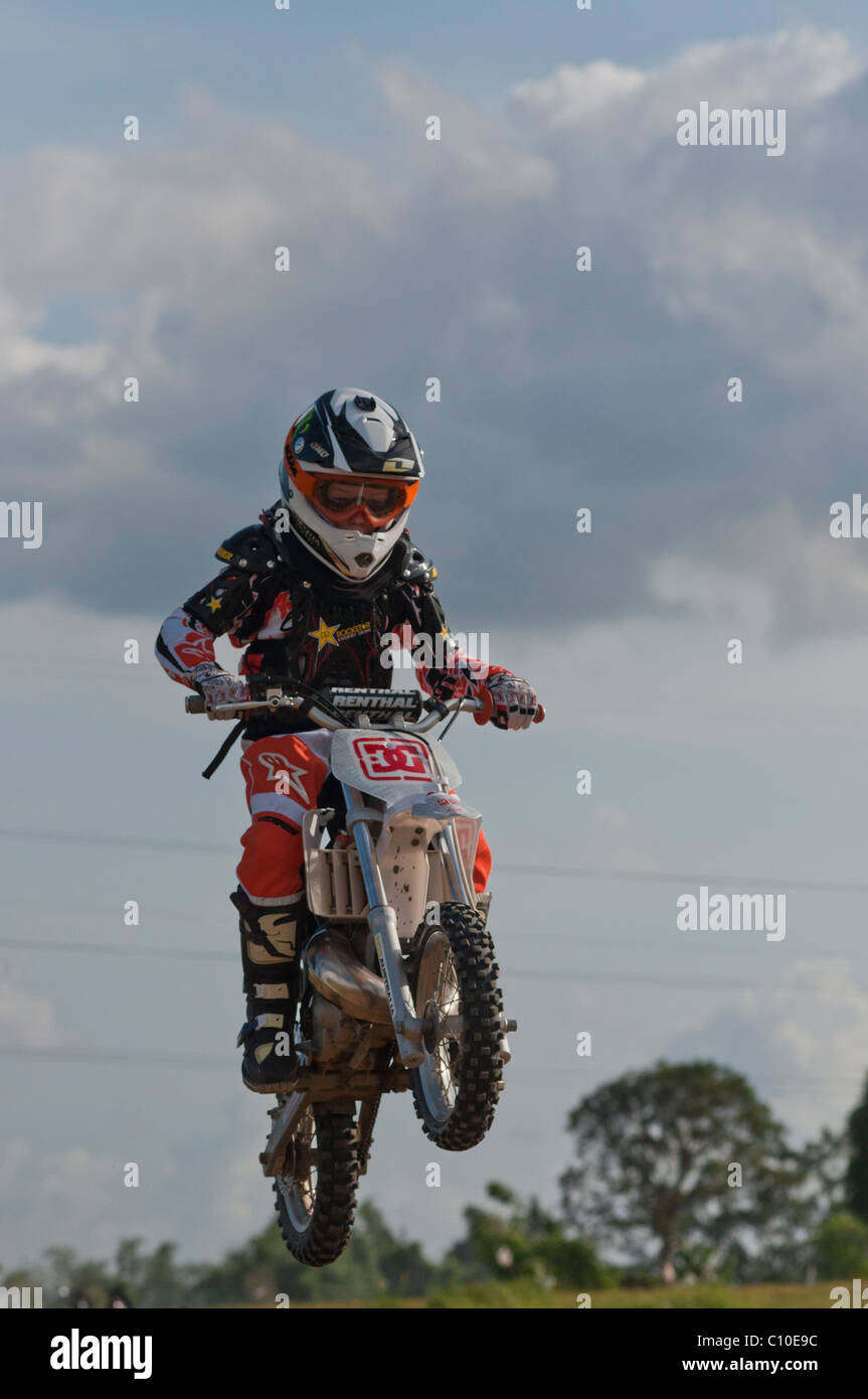 Un garçon de six ans avec son vélo motocross Banque D'Images