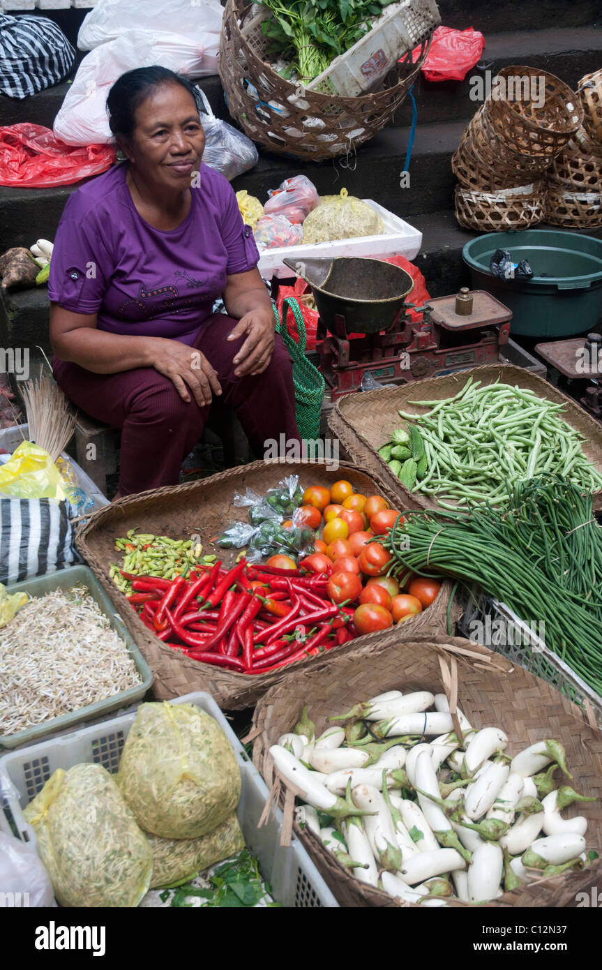 Woamn balinais assis avec ses marchandises dans le marché de Ubud, Bali, Indonésie Banque D'Images