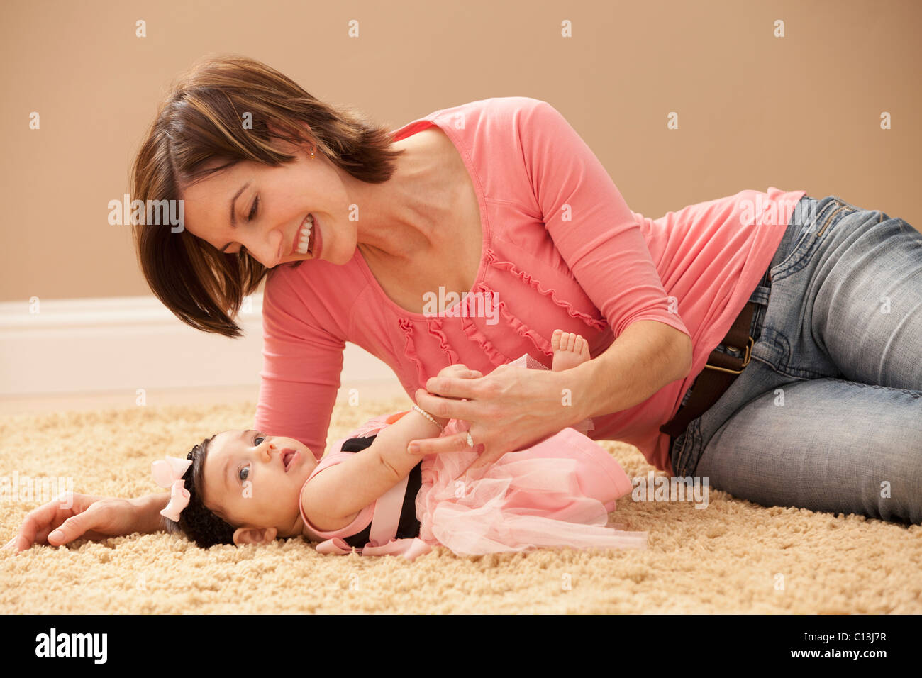 USA, Utah, Léhi, Woman with baby girl (2-5mois) lying on floor Banque D'Images