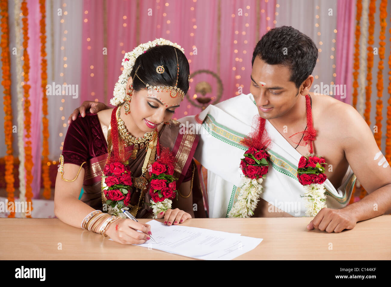 Couple de signer un certificat de mariage Banque D'Images