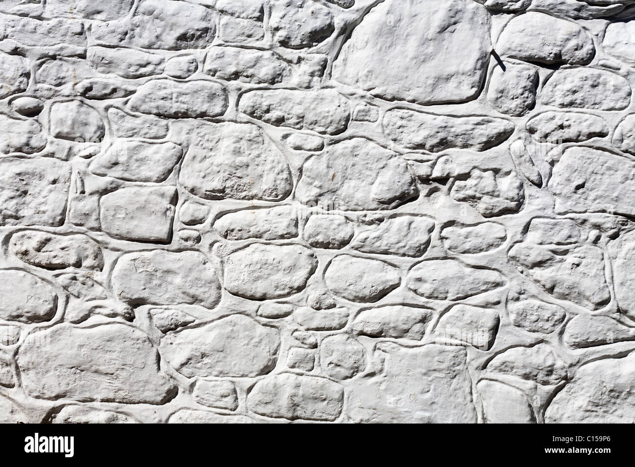 Mur de pierre blanchis à la chaux. Le côté d'un immeuble dans le petit village de pêcheurs de Mousehole sur la côte sud des Cornouailles). Banque D'Images